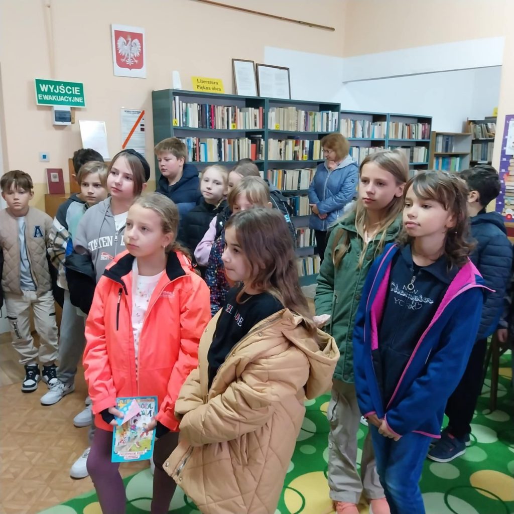 Uczniowie stoją w bibliotece